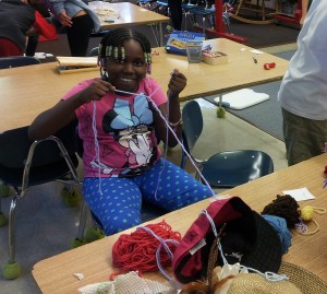 Timaya making a yarn bracelet!