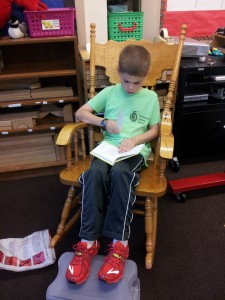 Ethan enjoying his book on the rocking chair!