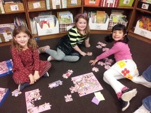 Lucy, Maya & Reyna putting together a puzzle